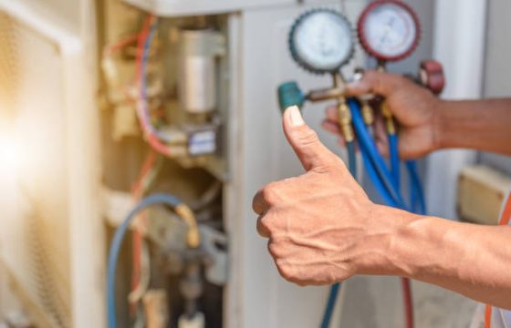 Close up of Air Conditioning Repair, repairman on the floor fixing air conditioning system